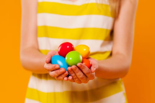 Close-up of multi colored easter egg in hands