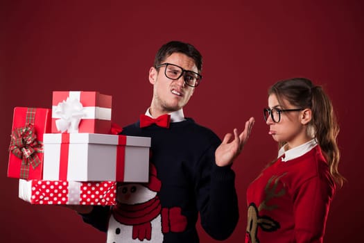 Rude nerdy man with christmas gifts