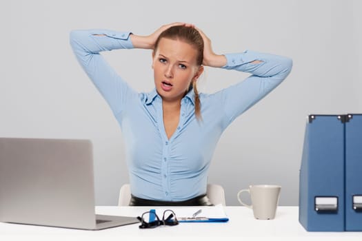 Portrait of terrified businesswoman with hands raised