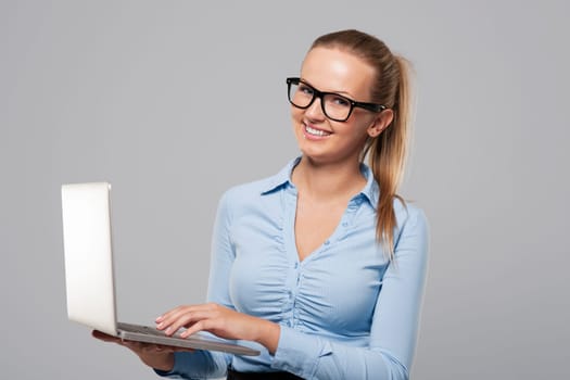 Beautiful young businesswoman using laptop