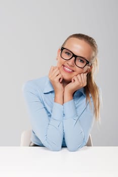 Portrait of cute sitting blond businesswoman