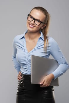 Gorgeous businesswoman holding laptop in hand