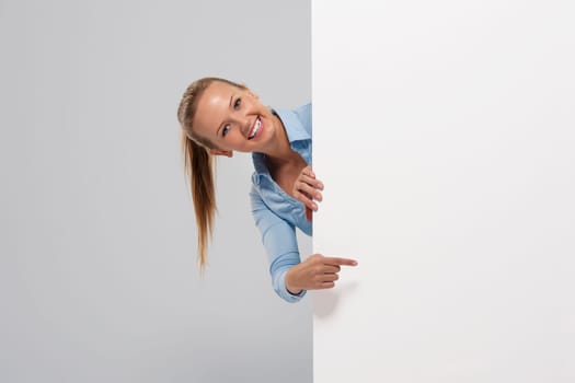 Smiling beautiful businesswoman pointing at whiteboard