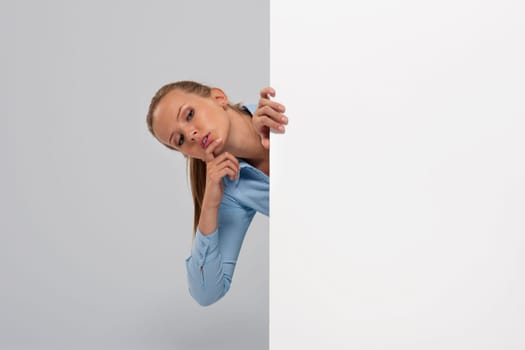 Curious businesswoman peeking at whiteboard