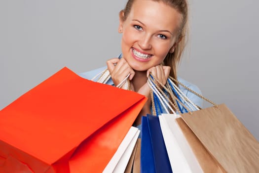 Smiling woman with a lot of shopping bags