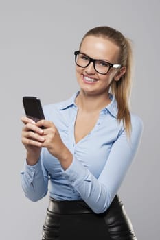 Beautiful blonde businesswoman with mobile phone