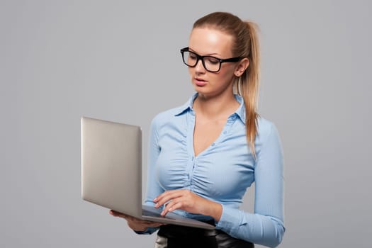 Focus blonde businesswoman using modern laptop