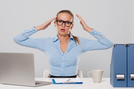 Portrait of shocked businesswoman with hands raised