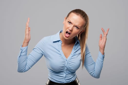 Portrait of shouting blonde businesswoman