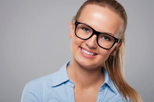 Close up of beautiful blonde woman wearing glasses