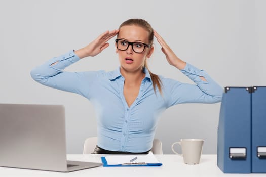 Portrait of shocked businesswoman with hands raised