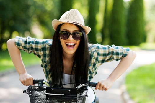 Happy young woman with bicycle