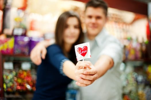 Couple holding lollipop in their hands