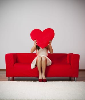 Elegant and fashion woman holding heart shape pillow