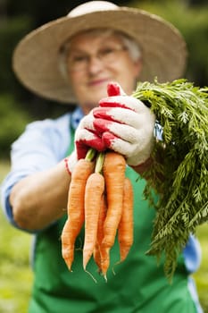 Senior woman with carrots