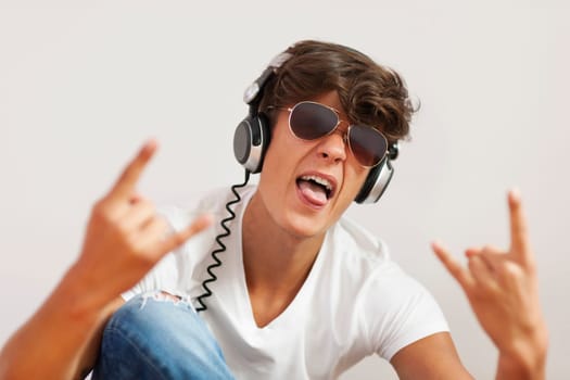 Excited young man listening hard rock music