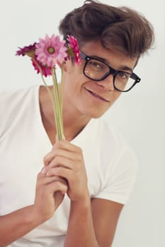 Nerd guy offering pink flower
