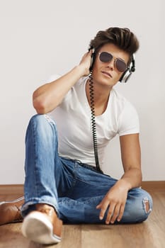 Relaxed young man listening to music on headphone
