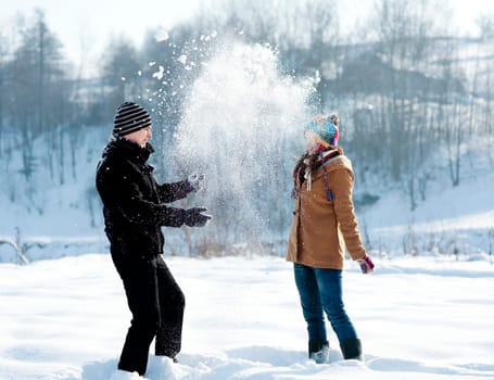 Young couple playing with snow