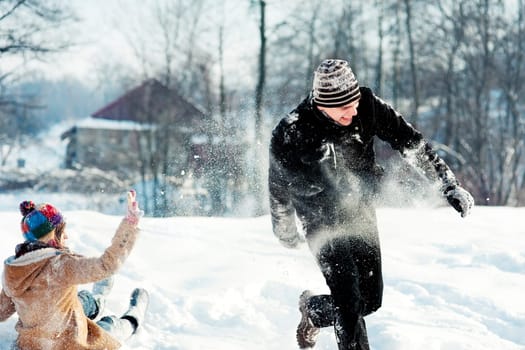 Young couple playing with snow