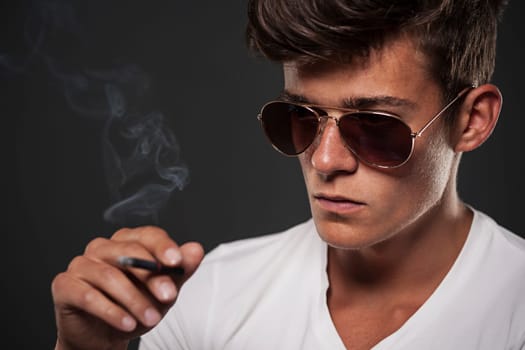 Focus young man with black cigarette