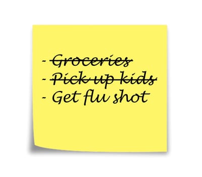 Sticky note reminder to get flu shot, black on yellow