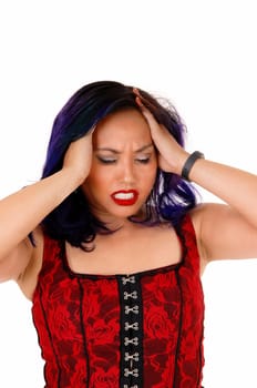 A pretty Asian woman in a red corset holding her head, standing for white.background with headache..
