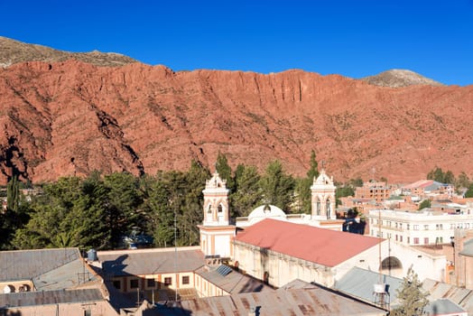 Cathedral of Tupiza, Bolivia with beautiful red hills rising in the background