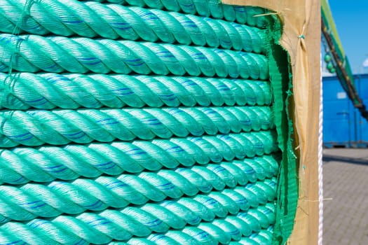 large roll with new green rope for the shipping industry