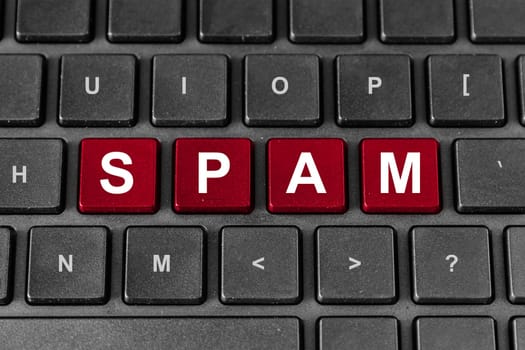 Spam red word on keyboard, technology concept