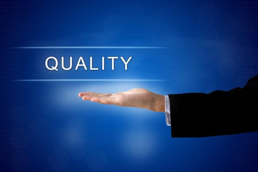quality button with business hand on a touch screen interface