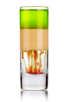 Shot sliced alcohol cocktail with drops isolated on white background