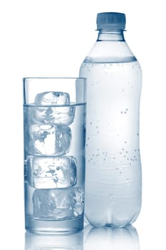 Bottle of mineral water and glass with ice cubes isolated on white