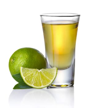 Gold tequila shot with lime isolated on white background