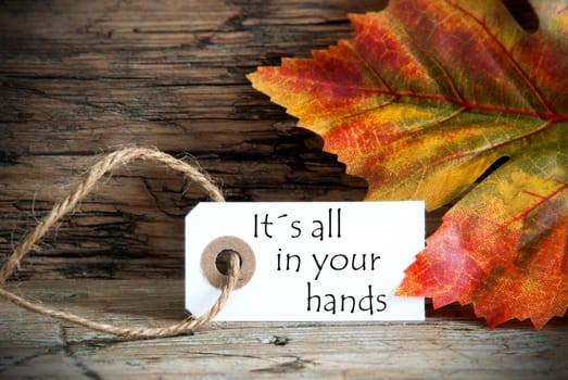 A Autumn Background with a Label on which stands Its all in your hands