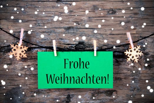 A Green Label with the German Words Frohe Weihnachten, which means Merry Christmas on it, Snowy Christmas Background