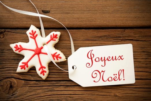Joyeux Noël, which is French and means Merry Christmas, on a Label with a red white Christmas Star Cookie