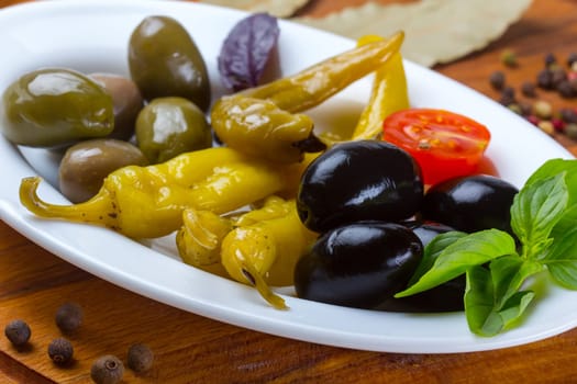 Plate with grilled pepper, assorted olives and spices