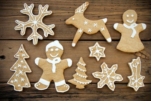 Gingerbread Cookies with White Decoration on Wood, Christmas and Winter Background