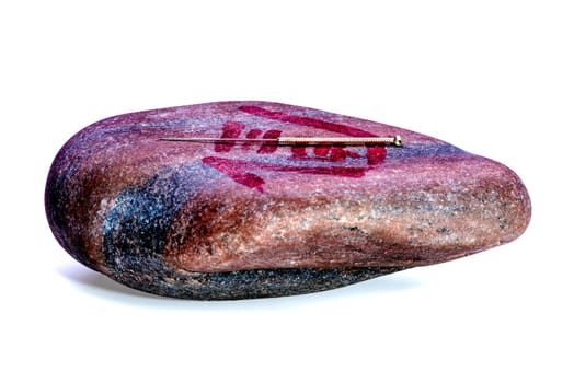 Acupuncture needle on stone