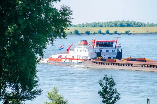 Cargo ship on the Rhine in Germany in full speed.