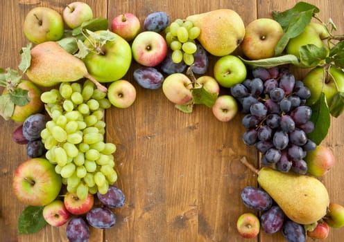 Fresh organic autumn fruits on rustic wood