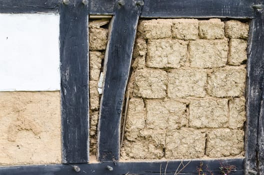 Medieval house wall plastered with clay,the beams marked