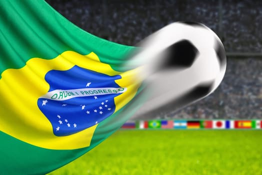 Football flies in front of waving Brazilian flag