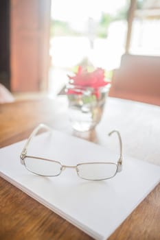 Eyeglass place on wooden table, stock photo