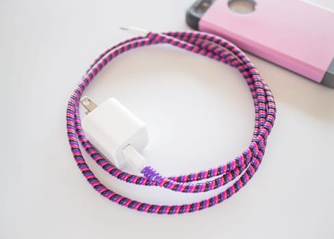 Smart phone charger with plastic cover on white background, stock photo