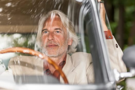 An image of a man in his historic car