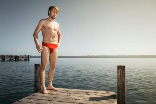 An image of a handsome man at the lake