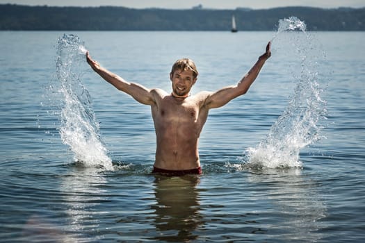 An image of a handsome man at the lake