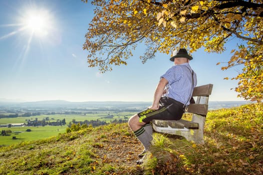 A traditional bavarian man in the autumn nature